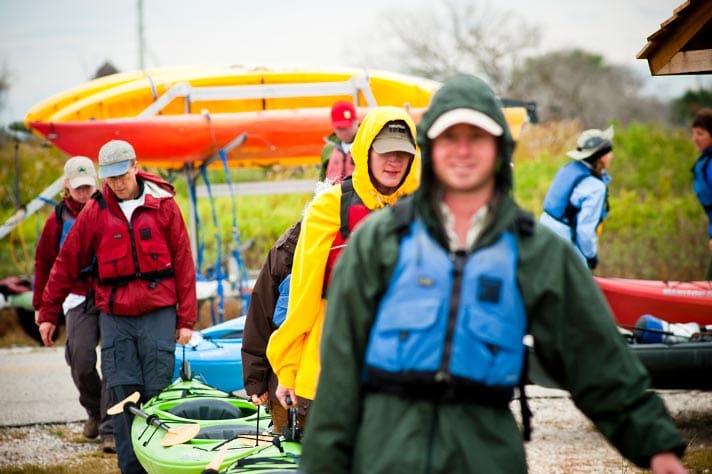 Coastal Restoration Toolkit image of nonprofit volunteers with kayaks to illustrate wildlife and coastal conservation marketing, branding, and web design agency case study.