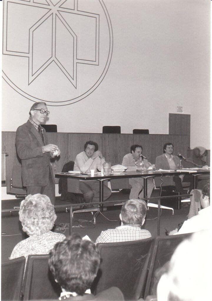 Photo of Ray Hyman, one of the psychologists who determined Hick's Law, speaking at a 1983 conference.