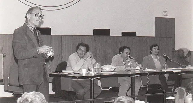 Black and white photo of Professor Hyman in class with students