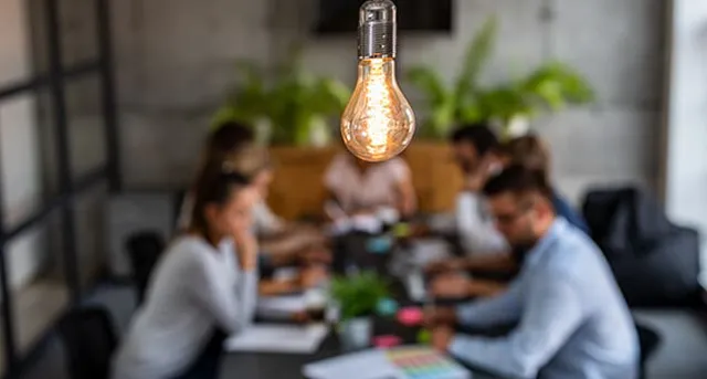 Employees sitting around a table discussing projects